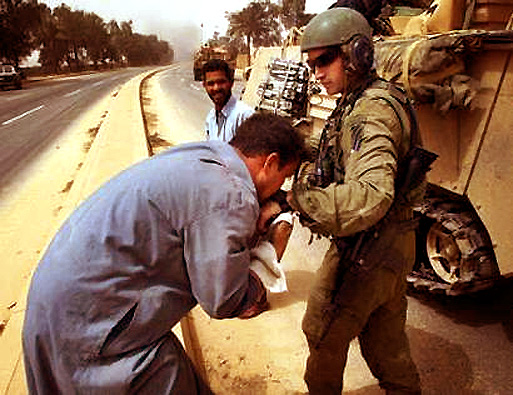 An Iraqi man kisses the hand of Capt. Andy Maclean of Task Force 2-69 Armor, 3rd Brigade Combat Team, 3rd Infantry Division from Fort Benning located in Georgia, Baghdad, April 9, 2003.